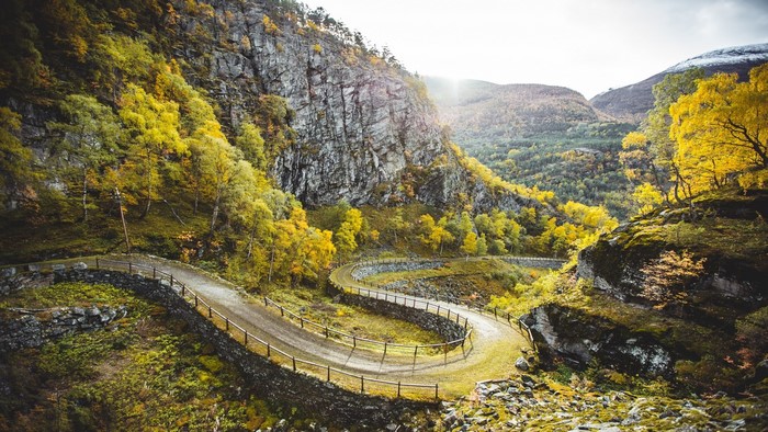 Winding mountain road with autumn trees