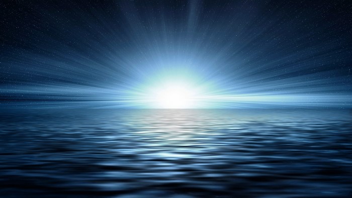 Bright light over the ocean at night
