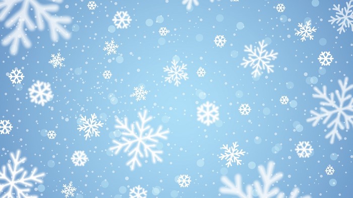 Winter snowflakes falling on blue background