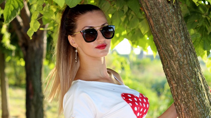 Woman with sunglasses and heart shirt