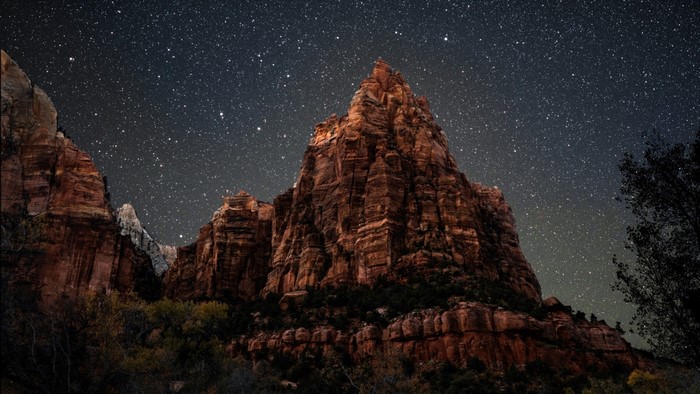 Mountain peak under a starry night sky