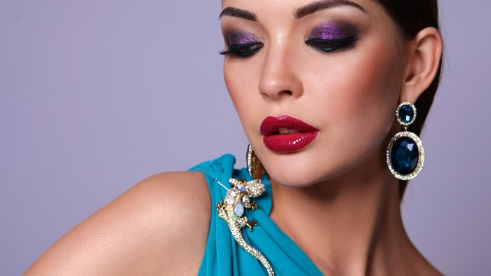 Woman with purple eyeshadow and red lipstick