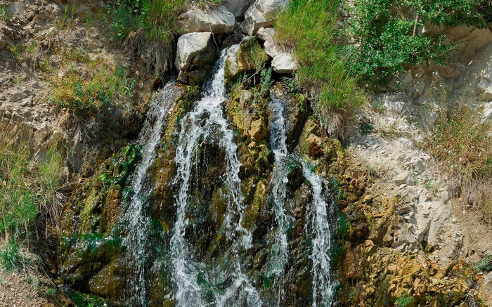 Waterfall cascading over mossy rocks