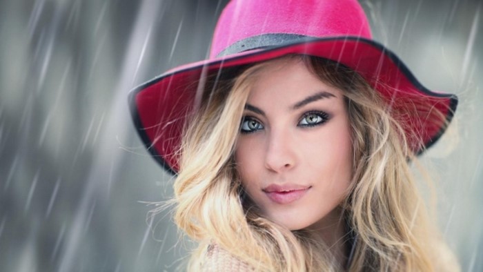 Woman in a pink hat in the rain