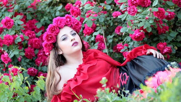 Girl with flower crown in rose garden