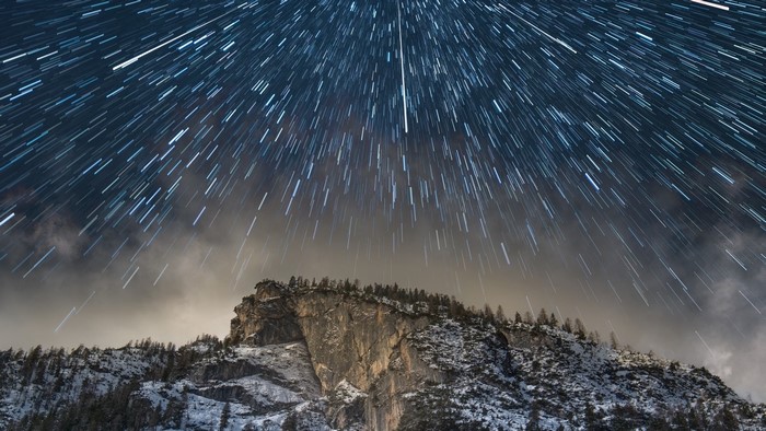 Star trails over snow-covered Dolomites