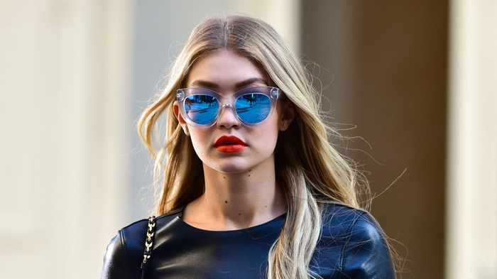 Gigi Hadid wearing sunglasses and orange lipstick