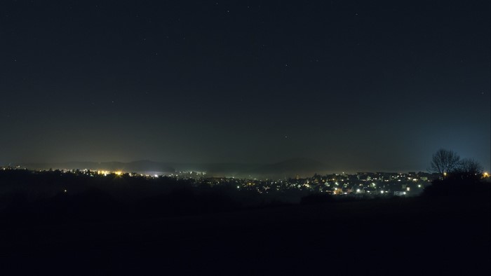 Night city lights under starry sky