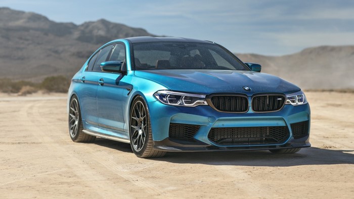 Blue BMW M5 Sedan on a Dirt Road