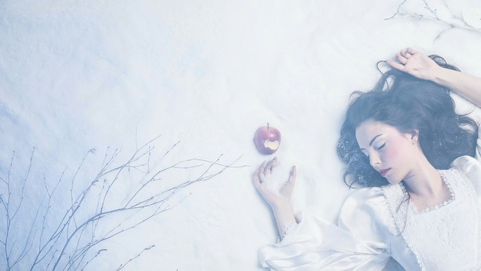 Snow White with poisoned apple in snow