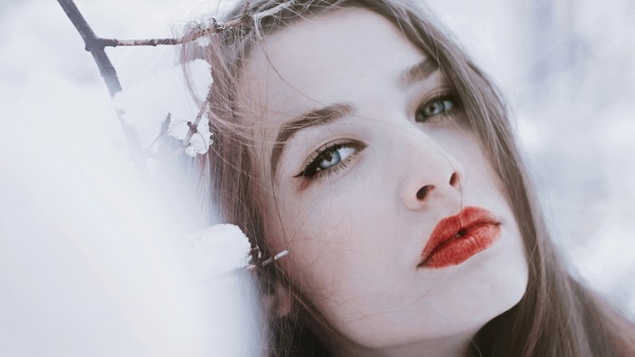 Woman with red lipstick in winter