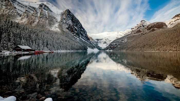 Winter landscape with snow-covered mountains and a lake