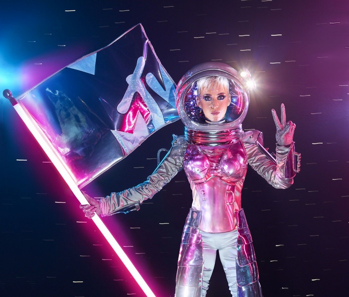 Katy Perry in astronaut costume holding MTV flag