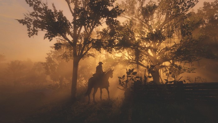Man on horse in foggy forest at sunrise