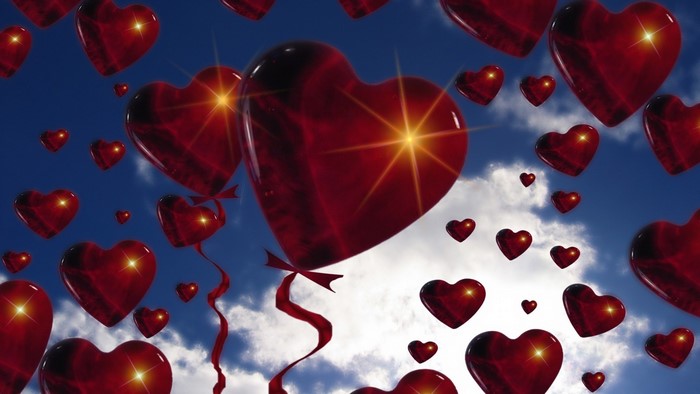 Red Heart Balloons Floating in a Blue Sky