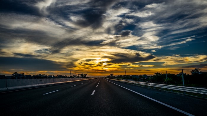 Highway at sunset with dramatic clouds