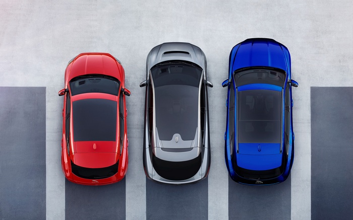 Three Jaguar SUVs parked in a lot