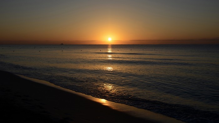 Sunrise over the ocean with a beach