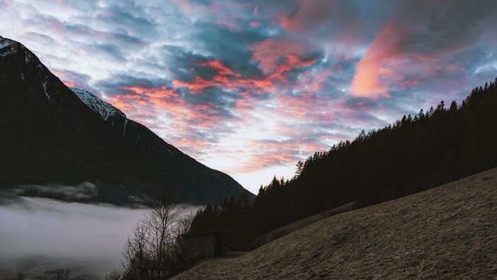 Sunset over foggy valley in South Tyrol