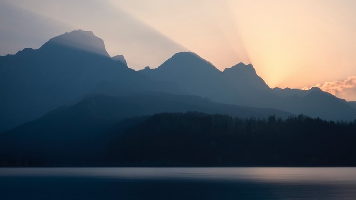 Mountain range silhouette over a lake at sunset