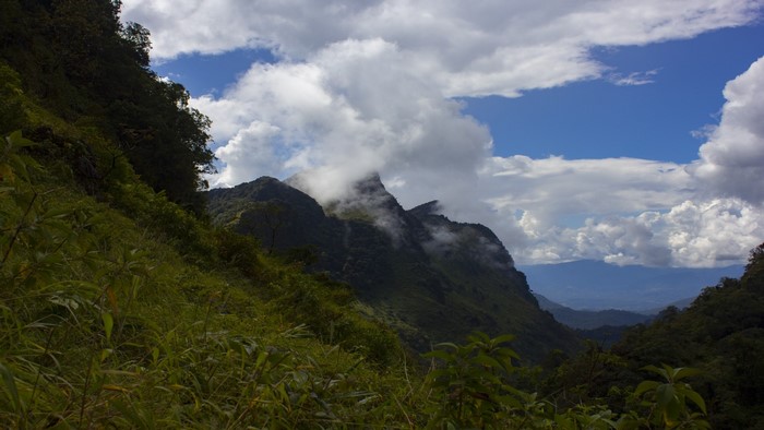 Mountains with clouds and green slopes