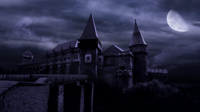 Castle at night with moon and clouds