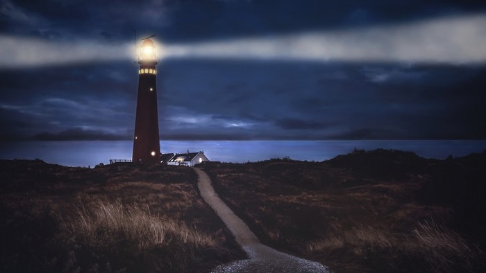 Lighthouse on a shore at night