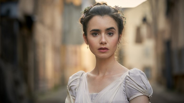 Lily Collins in historical costume with flowers in hair