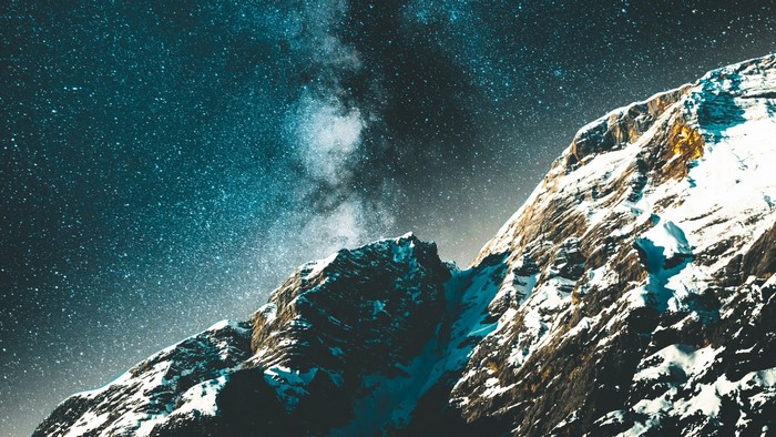 Snowy mountains under a starry sky