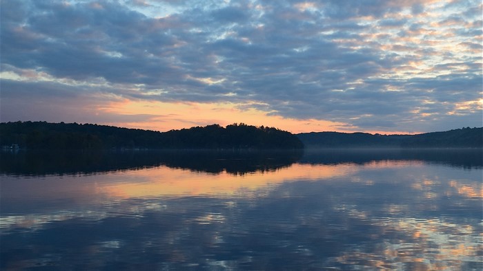Lake at sunrise with colorful clouds