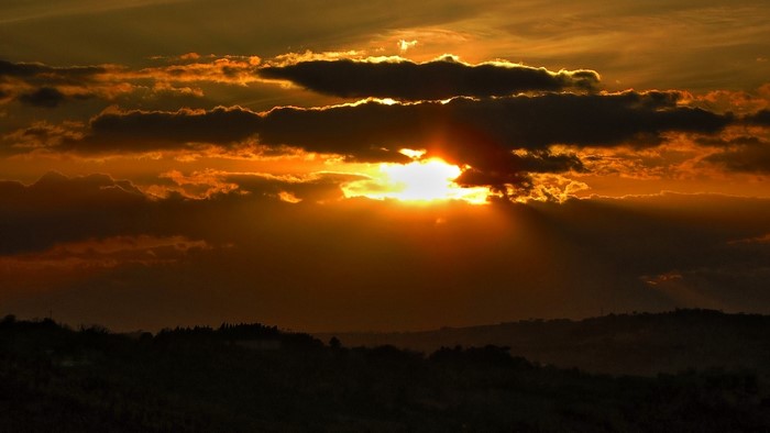 Sunset over rolling hills