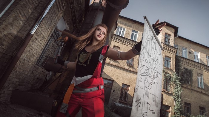 Brigitte from Overwatch Cosplay holding a blueprint