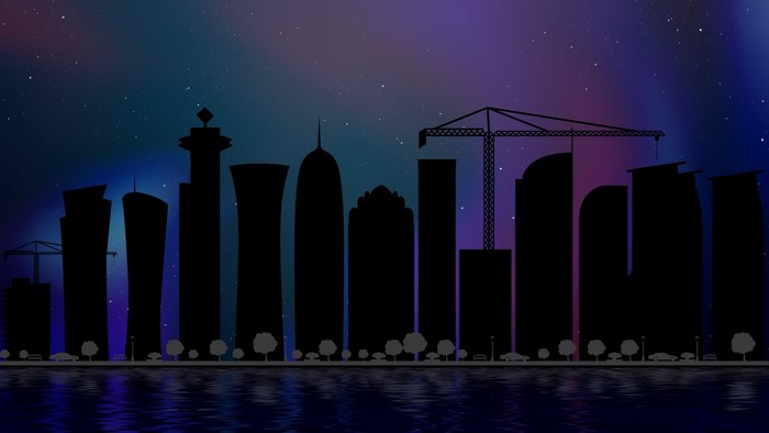 City skyline silhouette at night with starry sky