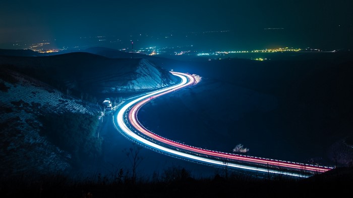 Long exposure of a highway at night with light trails