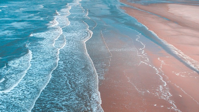 Ocean waves washing onto a sandy shore