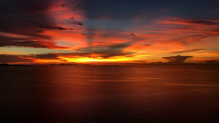 Sunset over the ocean with dramatic clouds