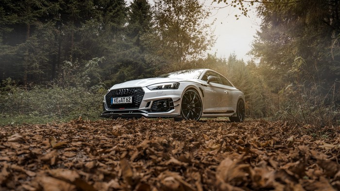 White Audi RS5 parked on a forest road
