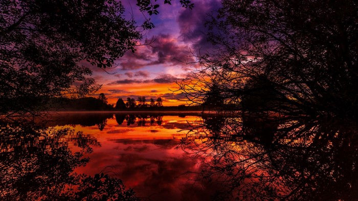 Sunset over a lake with trees