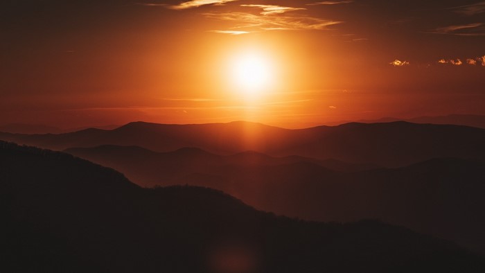 Sunset over layered mountains