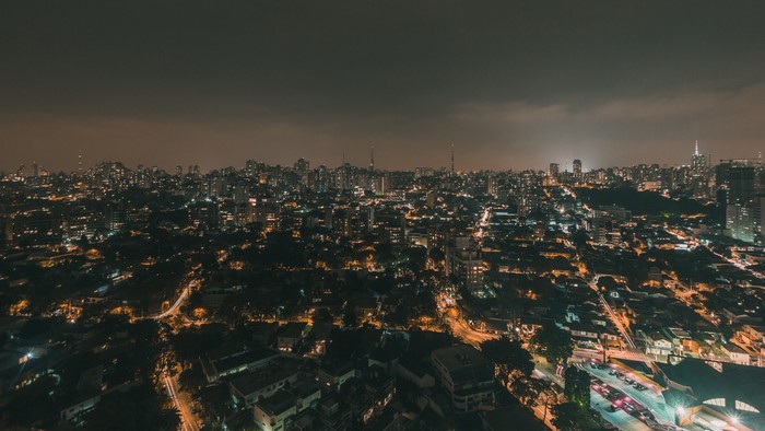 Night city skyline with illuminated buildings and streets