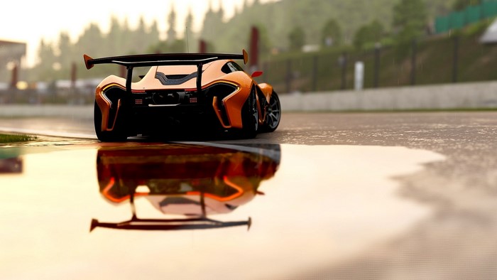 Orange McLaren P1 race car on wet track