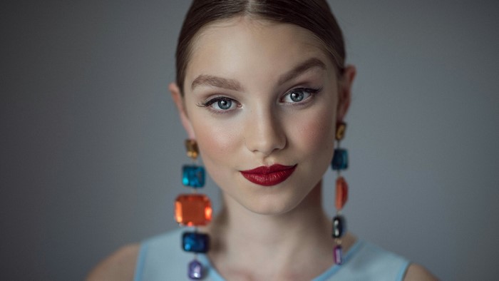 Young woman with colorful earrings