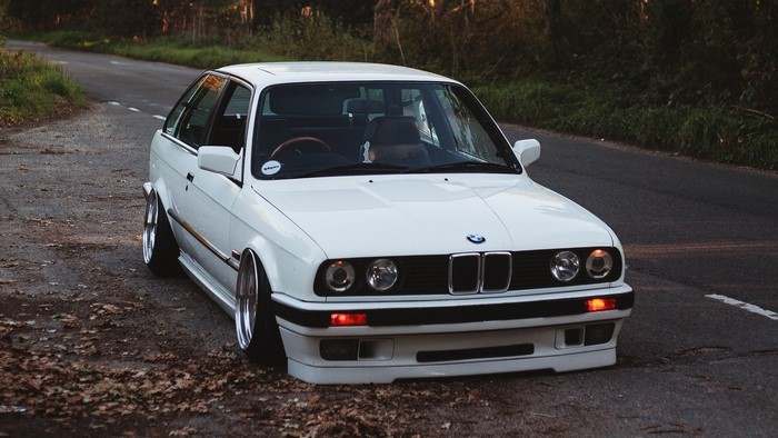 White BMW E30 Touring on a Road