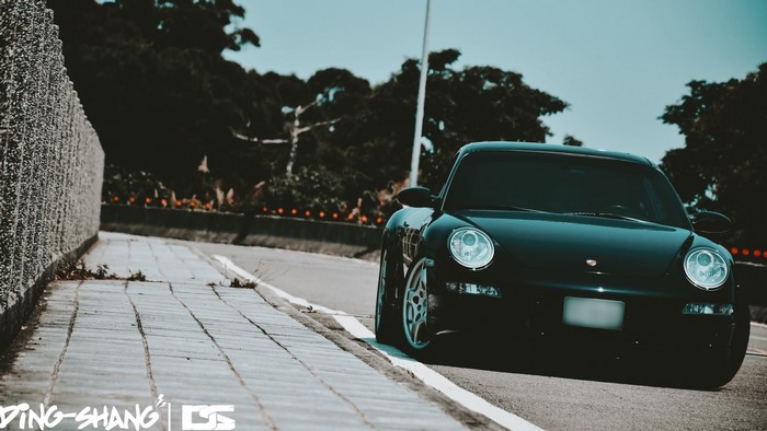 Black Porsche 997 on a Road