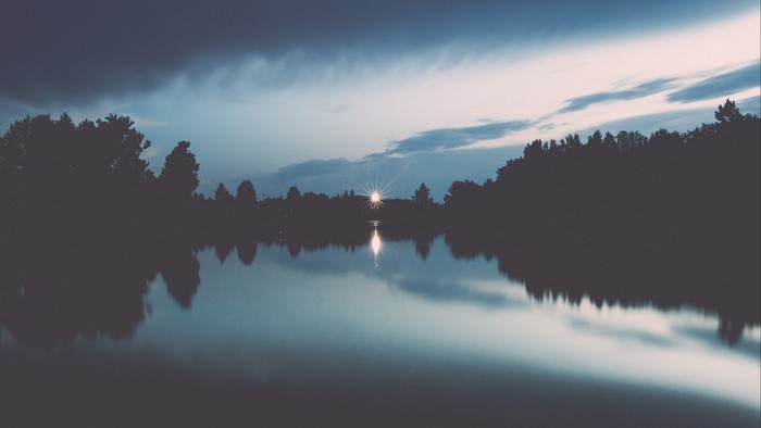 Lake at dusk with starburst light reflection