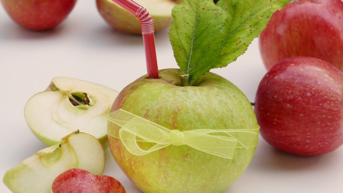 Still life of apples with a straw