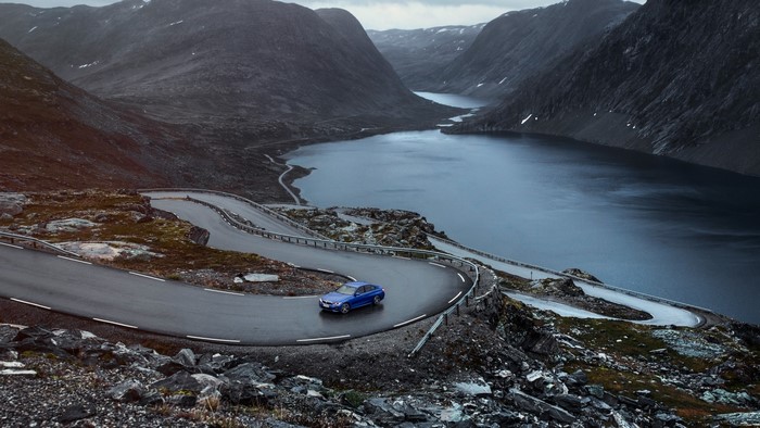 Blue BMW 3 Series G20 on a winding mountain road