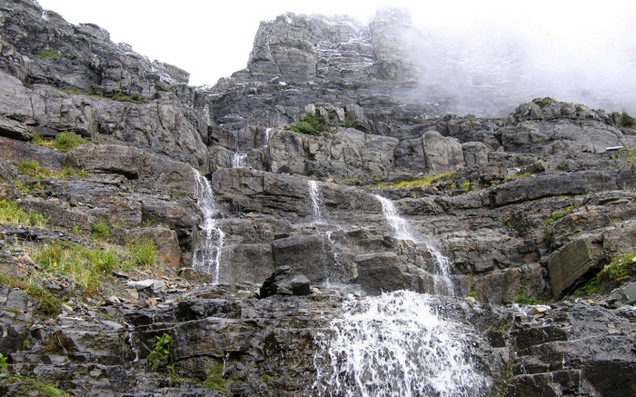 Waterfall cascading down a rocky mountain slope