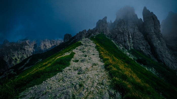 Rocky path on a foggy mountain slope