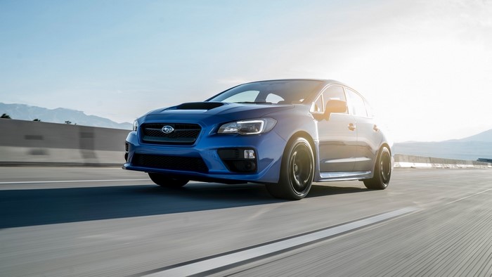Blue Subaru WRX STI driving on a highway